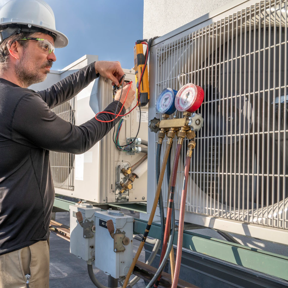 a person checking the hvac pressure gauge