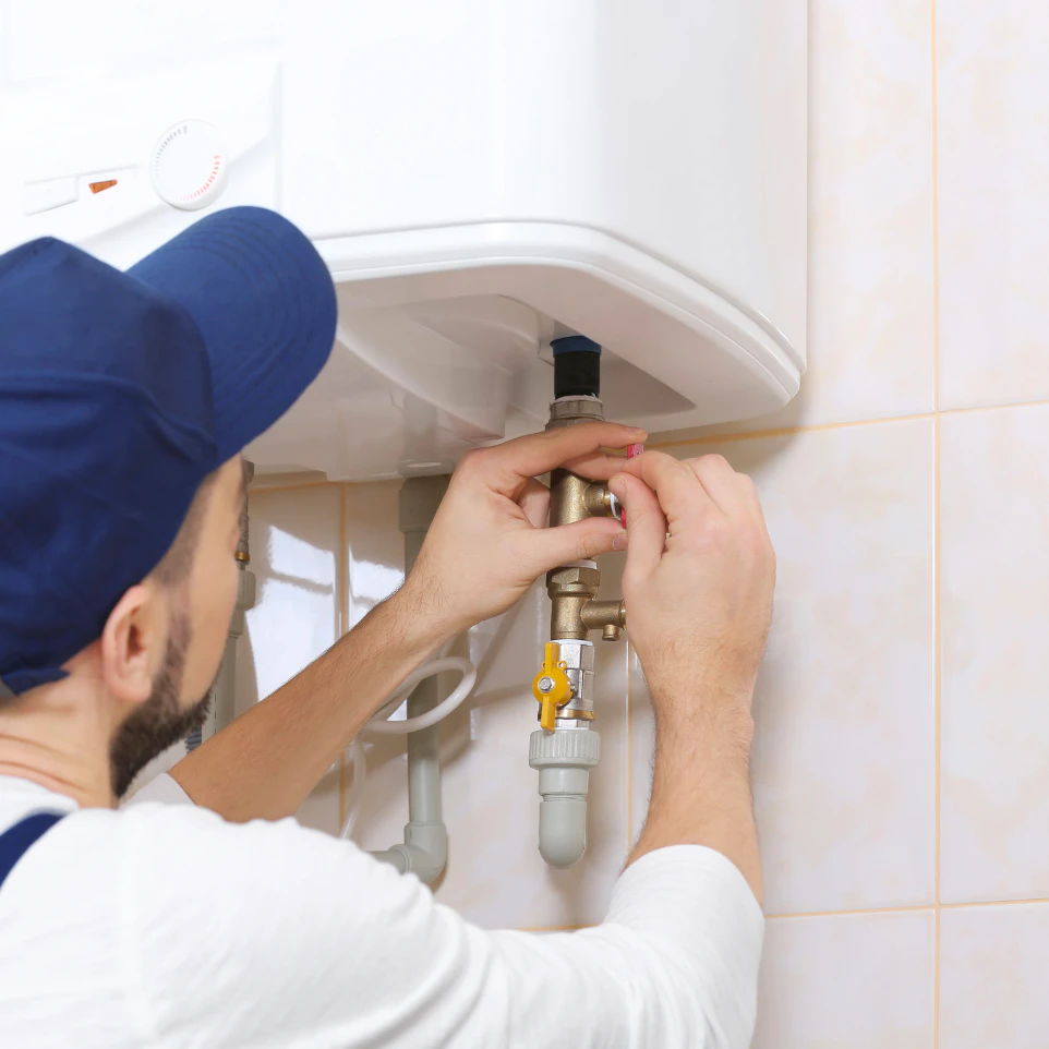 a person installing a tankless water heater